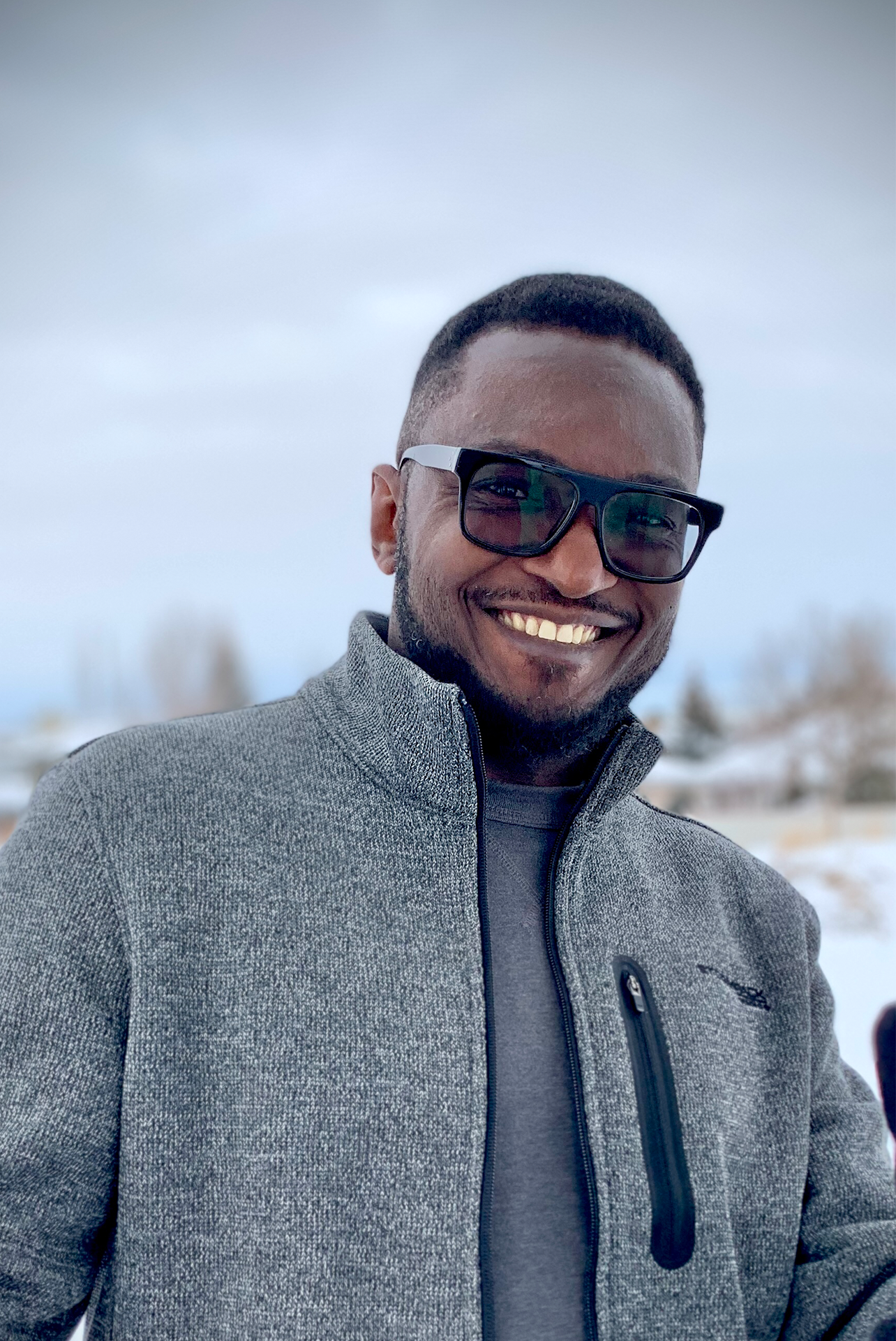 Kachi Eze standing in front of a snowy background